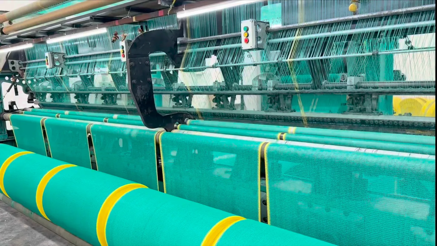 A warp-knitting loom running green shade net
